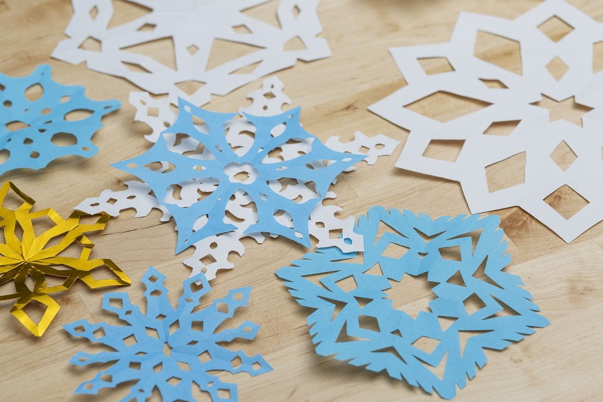 feature image of finished paper snowflakes